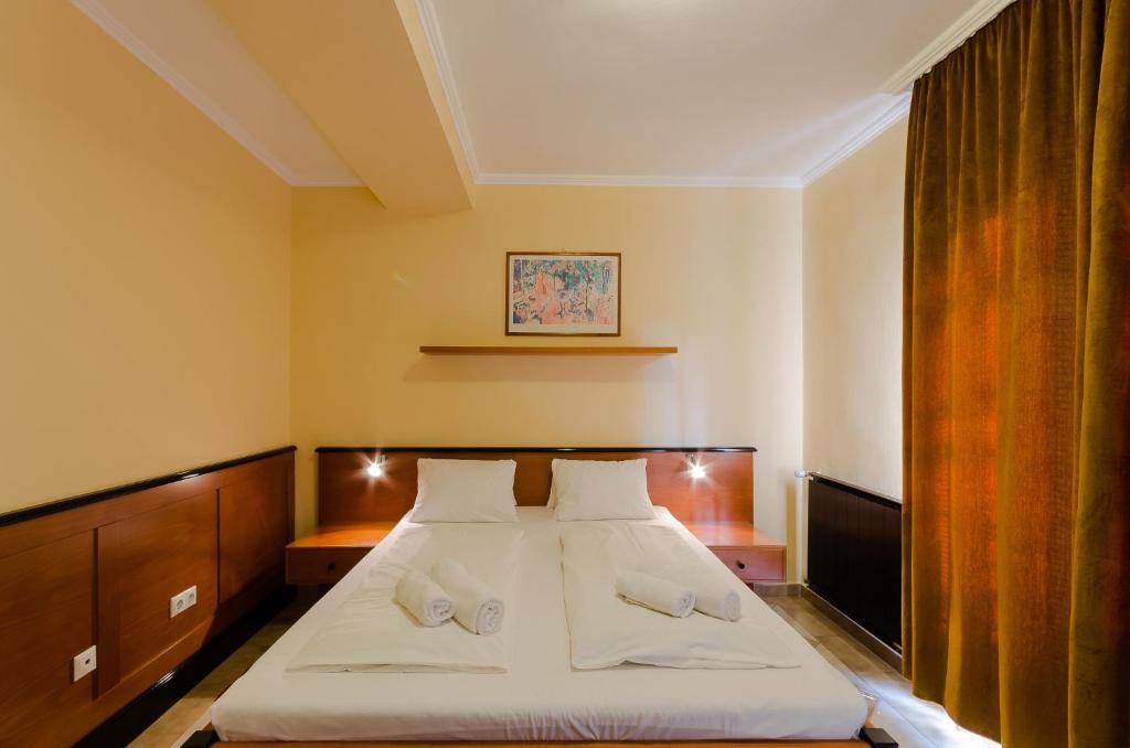 a bedroom with a bed with two white pillows at Richter Pansion in Budapest
