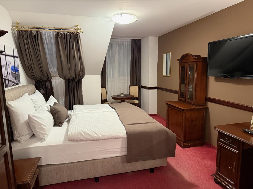 Postel nebo postele na pokoji v ubytování Hotel Kaiser