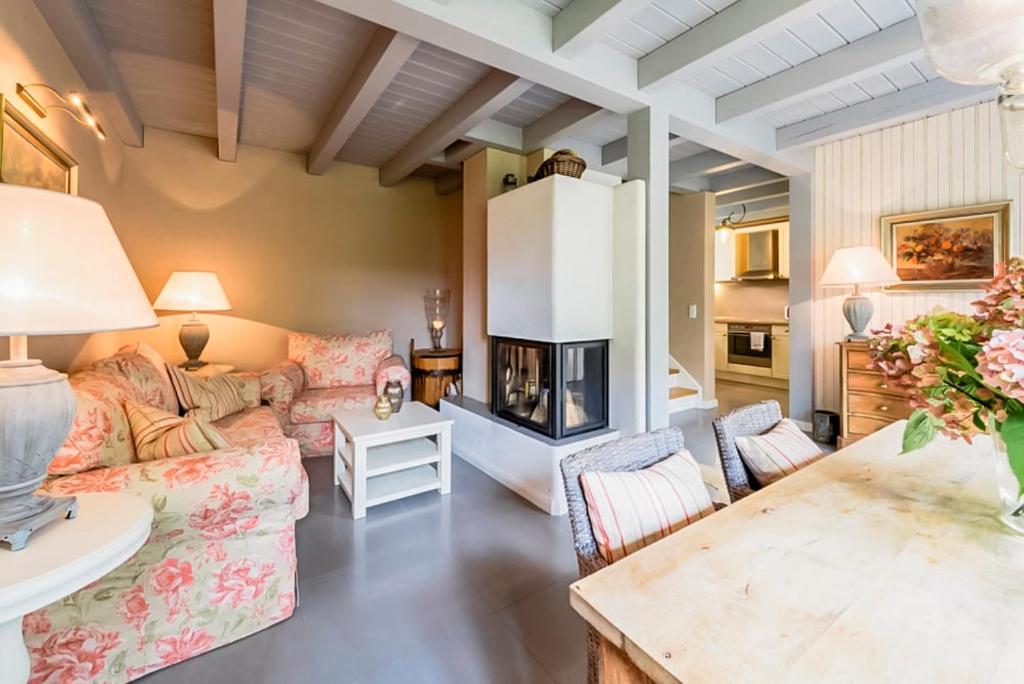 a living room with a couch and a fireplace at Bauernkate Seerose in Rankwitz