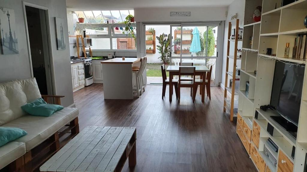 a living room with a couch and a table and a kitchen at Wide duplex 200 meters from the sea in Mar del Plata