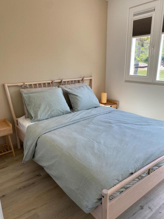 Postel nebo postele na pokoji v ubytování De Fazant - Tiny House in de Zeeuwse Natuur