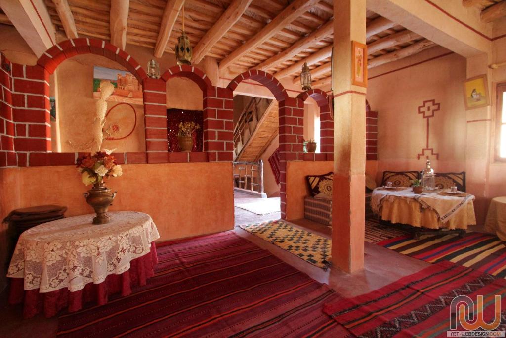 a large room with two tables in a building at Hotel Cascades Dades in Aït Ben Ali