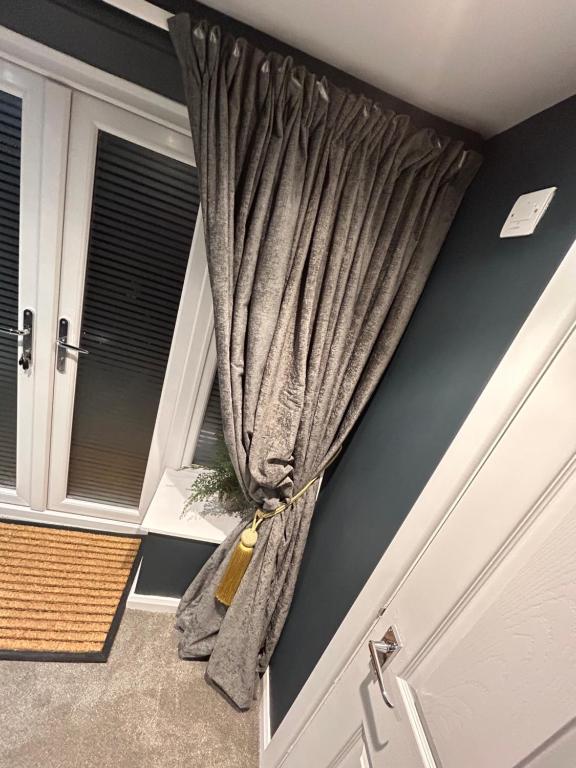 a curtain in a room next to a door at Aiskew Villa Annex in Bedale