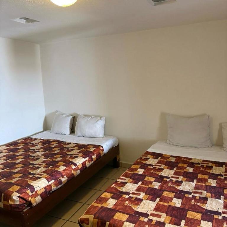 Postel nebo postele na pokoji v ubytování Hotel Meson de Carolina