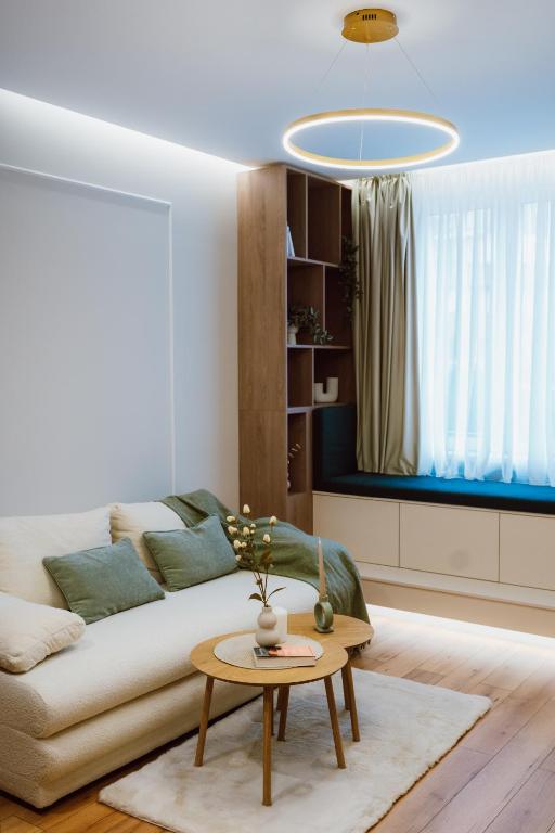 a living room with a couch and a table at SXB Skyline Luxury Suite in Braşov