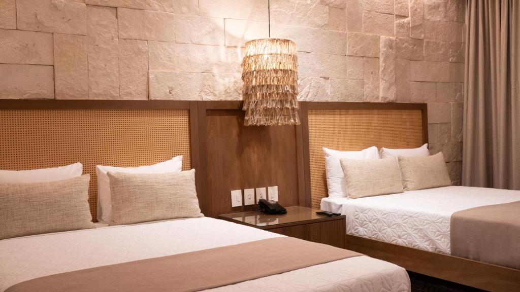 Postel nebo postele na pokoji v ubytování Hotel Mundo Maya Chichén Itzá