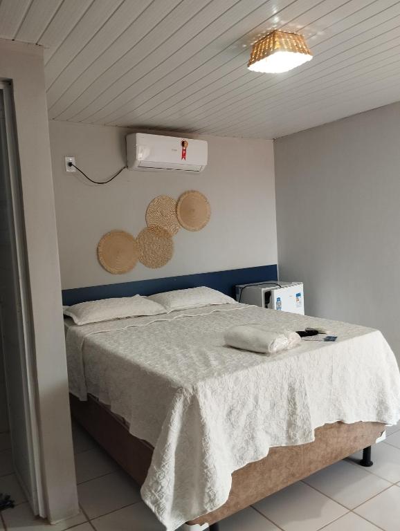 a bedroom with a bed with a white blanket at Ecovila Sertão in Petrolândia