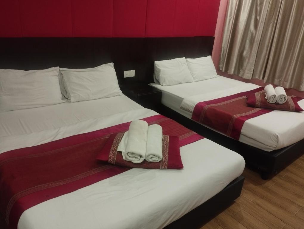 Postel nebo postele na pokoji v ubytování D'Spark Hotel Bayu