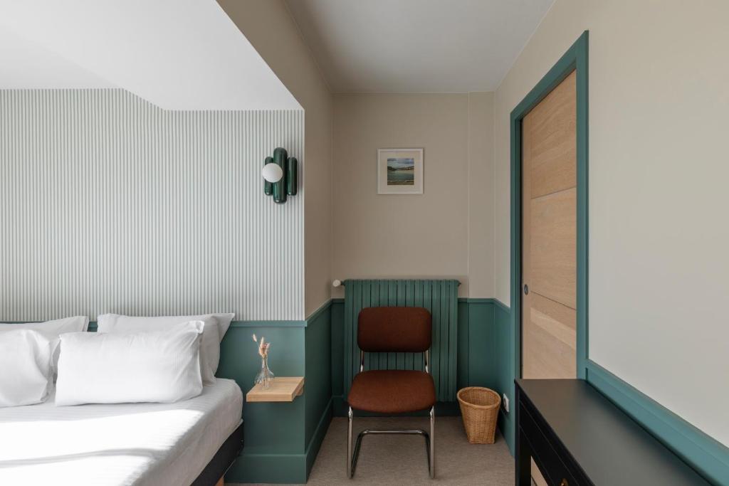 Postel nebo postele na pokoji v ubytování Hôtel BelleVue