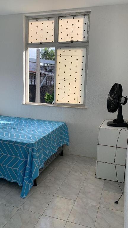 a room with a bed and a window at pousada vista in Salvador
