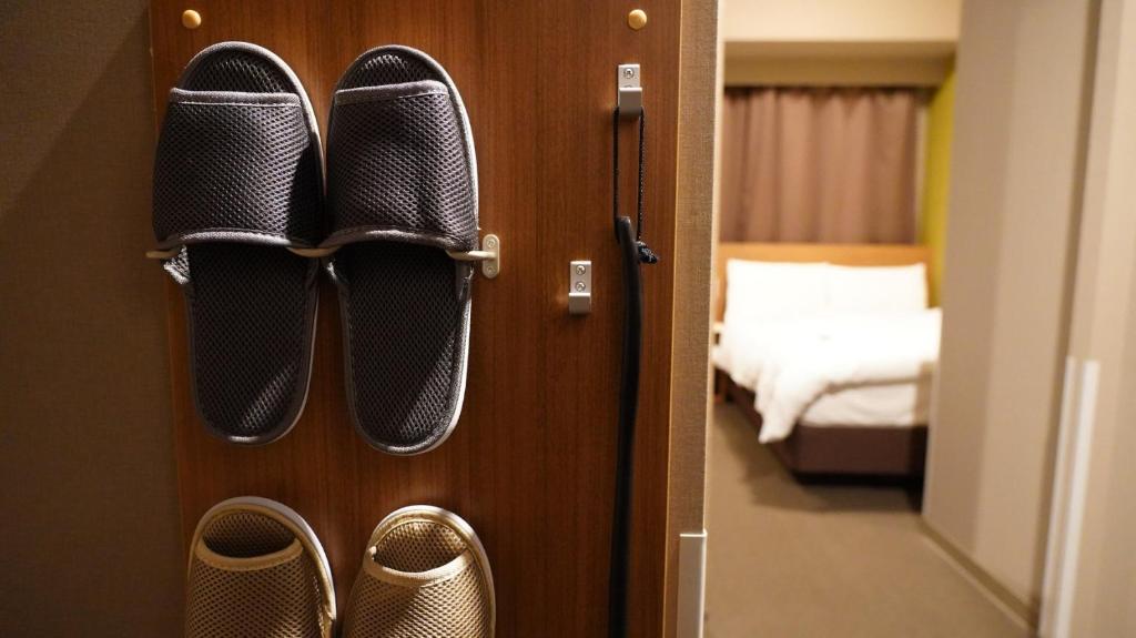 Postel nebo postele na pokoji v ubytování Dormy Inn Kobe Motomachi Natural Hot Springs