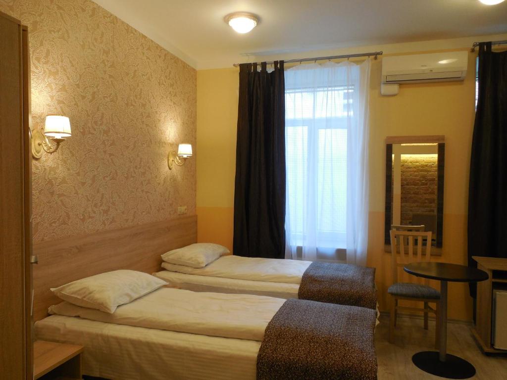 Postel nebo postele na pokoji v ubytování Gogol Park Rooms