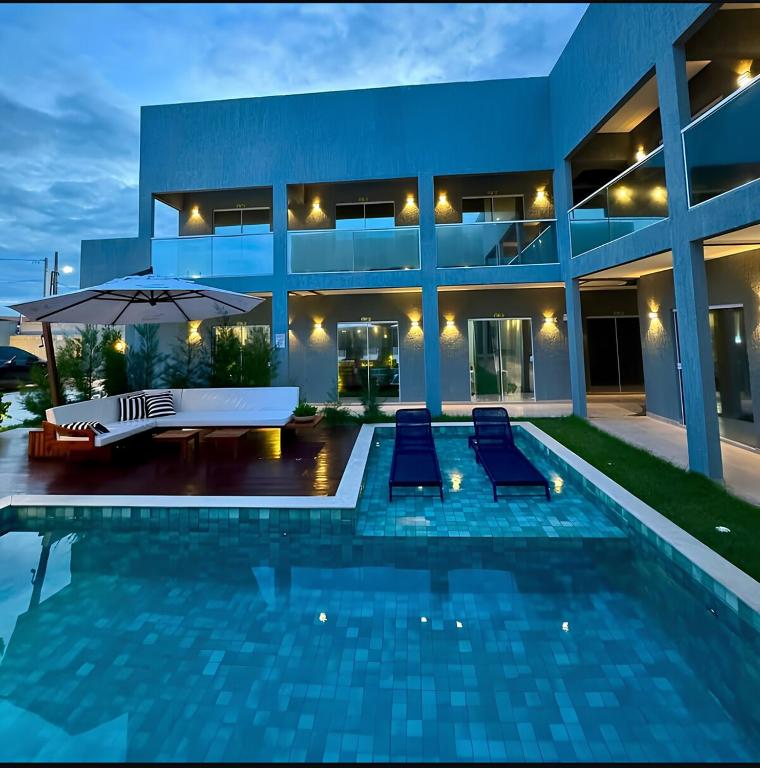 a villa with a swimming pool at night at Barra Grande Condomínio Vila Eco BG Apt T11 in Cajueiro