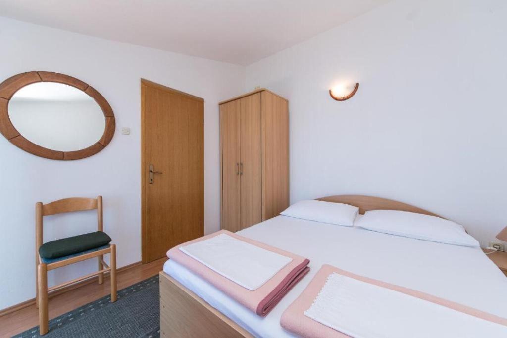 Postel nebo postele na pokoji v ubytování Apartments Gordan