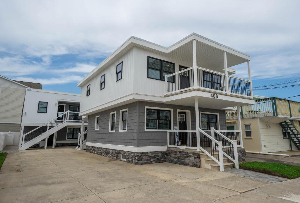 a large white house with a balcony on it at Surf Shore Properties in North Wildwood