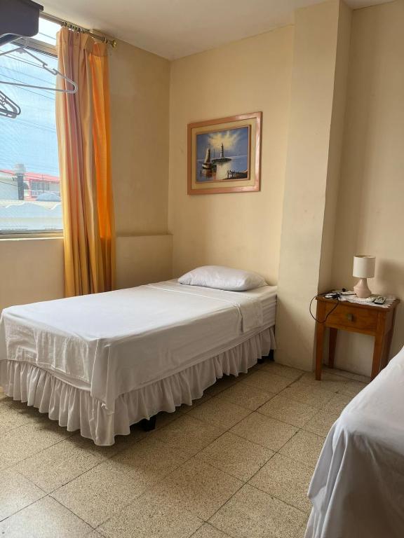 Postel nebo postele na pokoji v ubytování Hotel Mileto