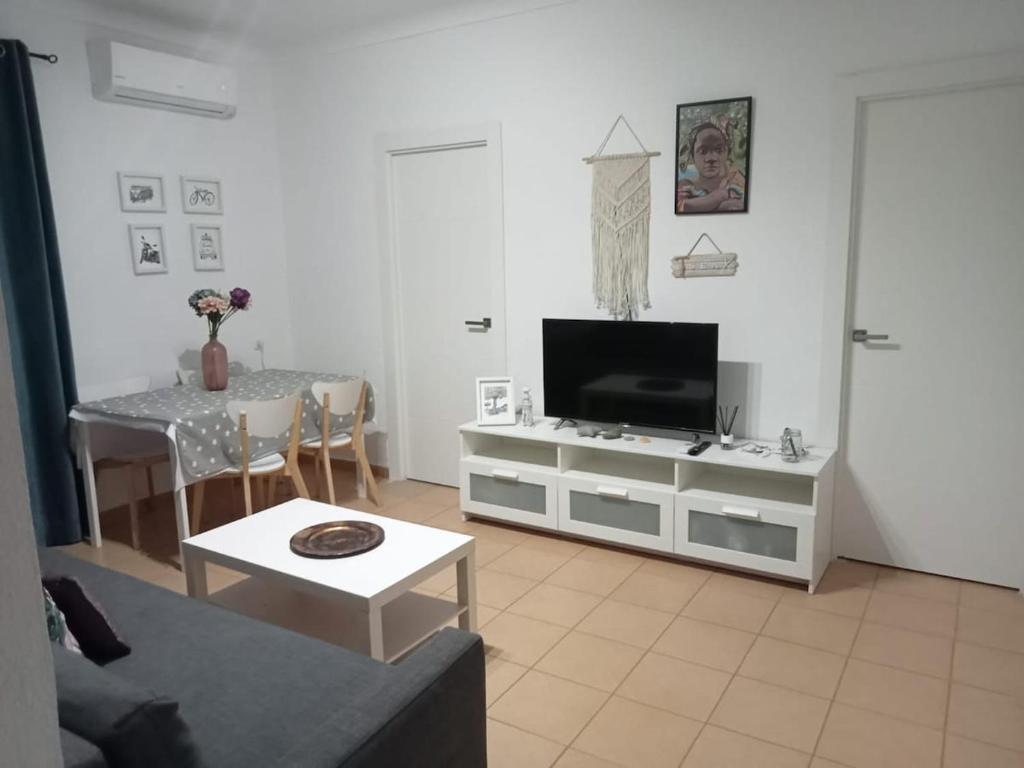 a living room with a television and a table at Piso Barbate in Barbate