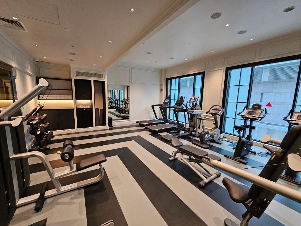 a gym with a row of treadmills and ellipticals at QT Singapore in Singapore
