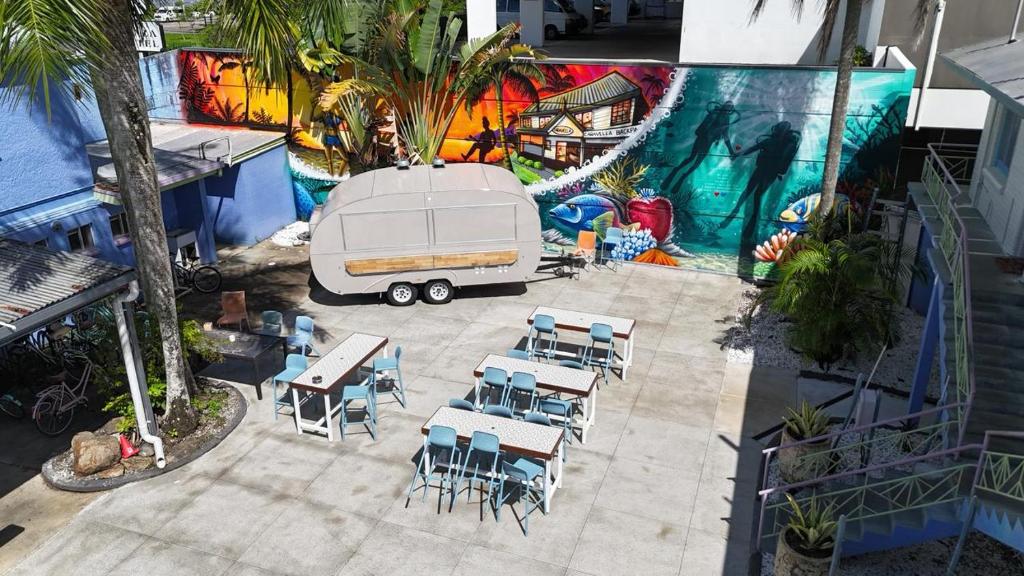 an aerial view of a white trailer with tables and chairs at Caravella Backpackers in Cairns