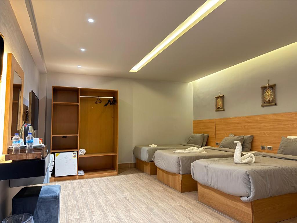 Postel nebo postele na pokoji v ubytování NUT Pyramids Hotel