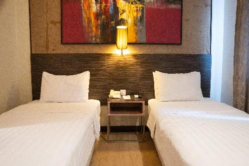 Postel nebo postele na pokoji v ubytování BRITS HOTEL PANGKALAN BUN