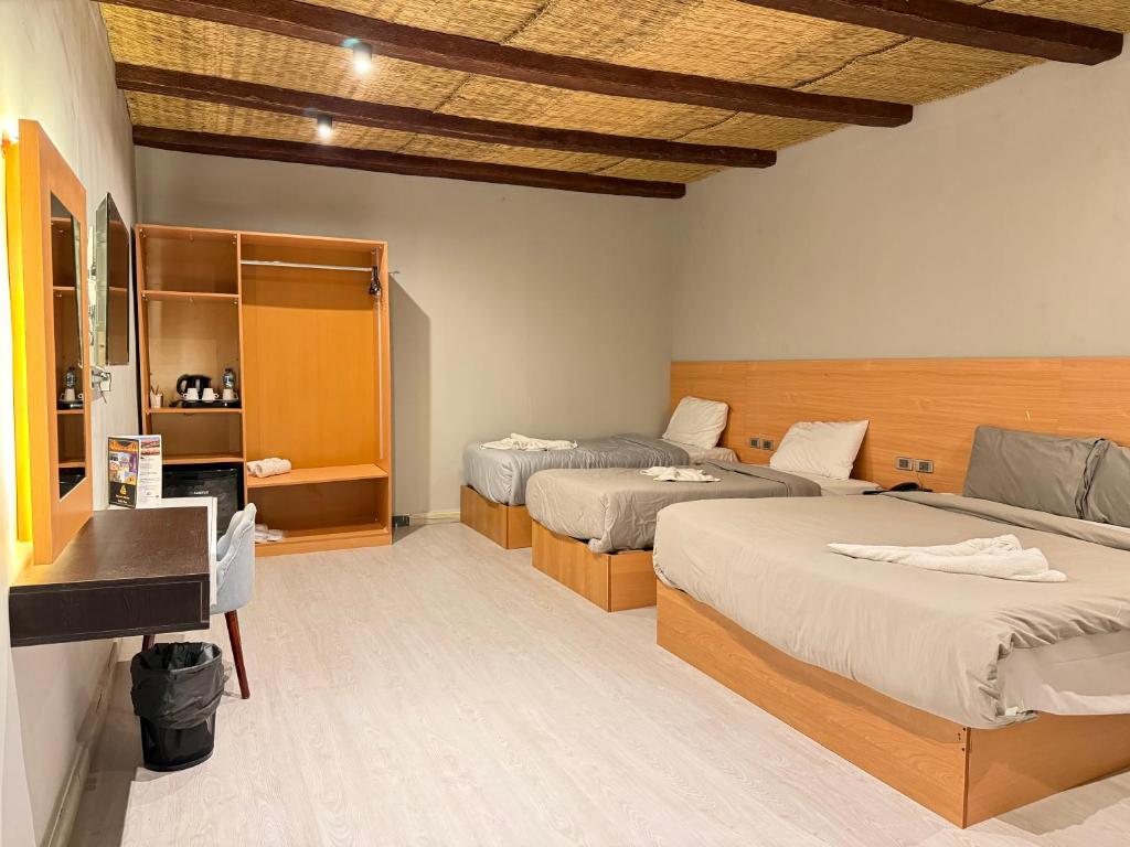 Postel nebo postele na pokoji v ubytování NUT Pyramids Hotel