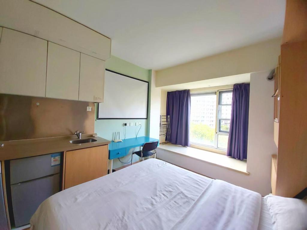 Kuchyň nebo kuchyňský kout v ubytování Qingdao Mi Apartment