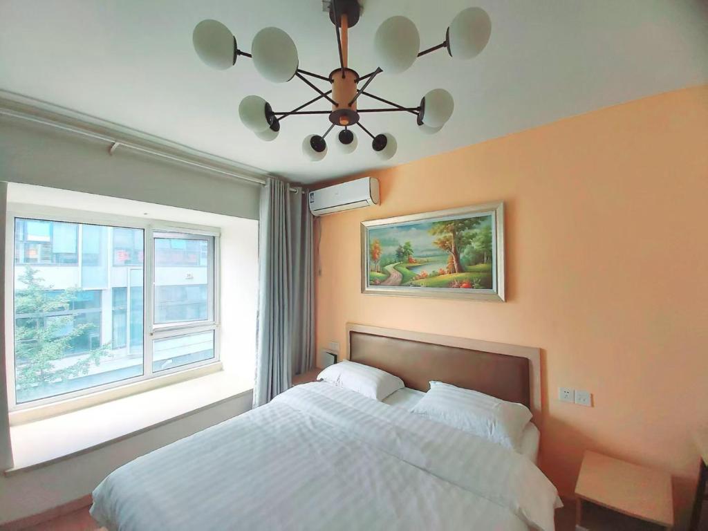 Postel nebo postele na pokoji v ubytování Qingdao Mi Apartment