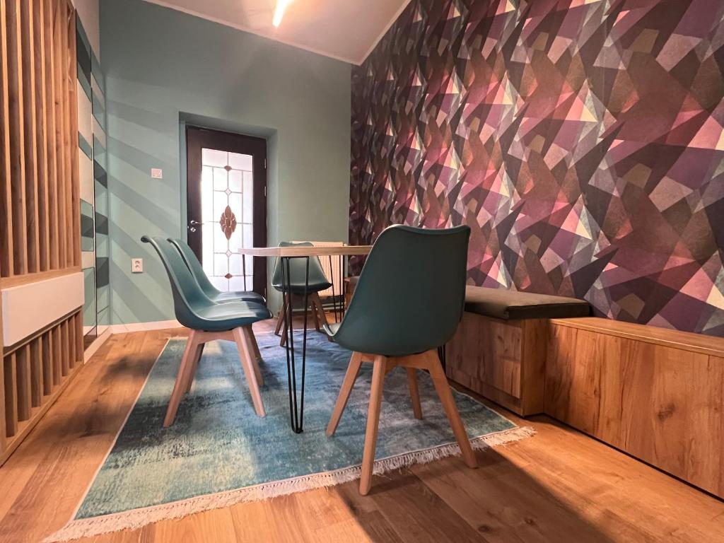 a dining room with two chairs and a table at Urban Waves with 2 bedrooms and terace in Constanţa