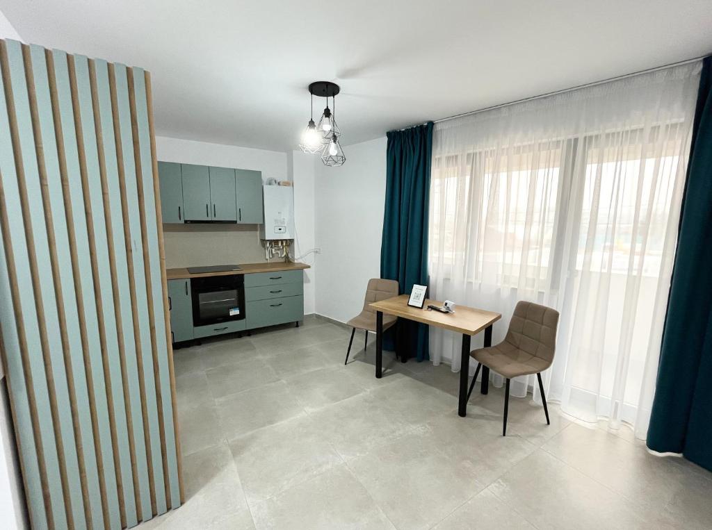 a kitchen and dining room with a table and chairs at ONE Apartment in Iaşi