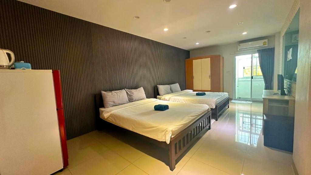 Postel nebo postele na pokoji v ubytování At Ease Hotel Suvarnabhumi