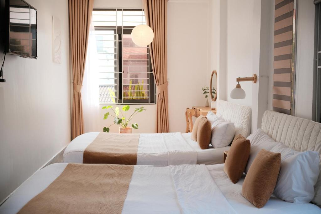 Giường trong phòng chung tại Glory Hue Homestay