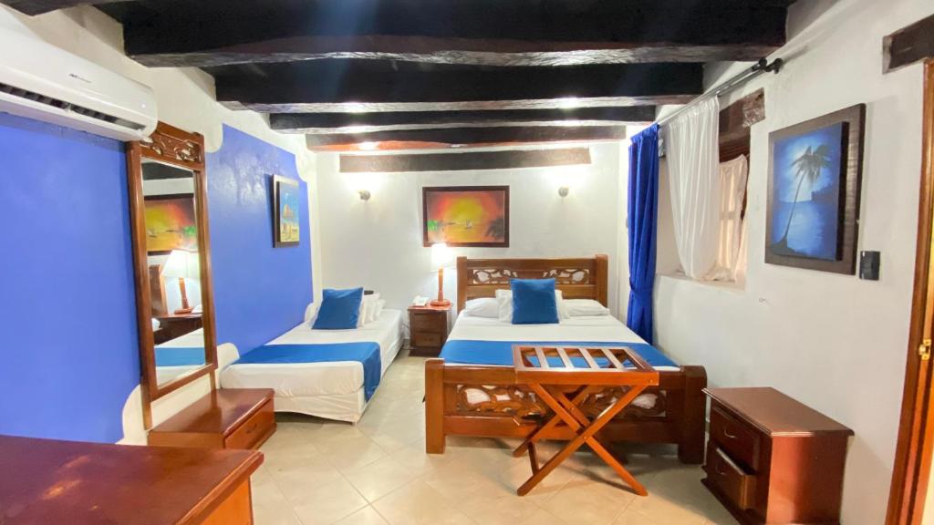 Postel nebo postele na pokoji v ubytování Hotel Don Pedro De Heredia