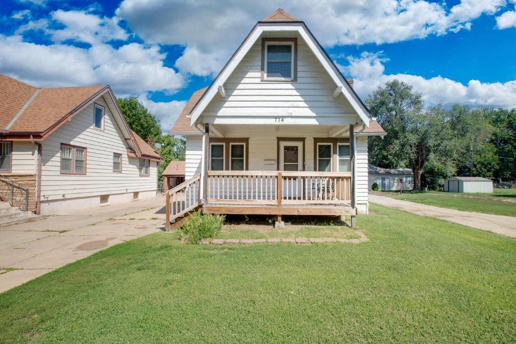 a white house with a porch and a yard at Home Sweet Home - Loft 3 BR - 1 BA WIFI SMART TV in Wichita