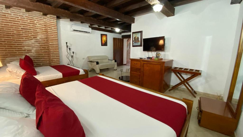 Postel nebo postele na pokoji v ubytování Hotel Don Pedro De Heredia