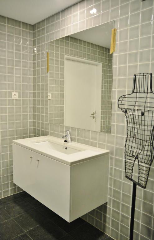 a bathroom with a white sink and a mirror at Aldeia do Priolo in Nordeste