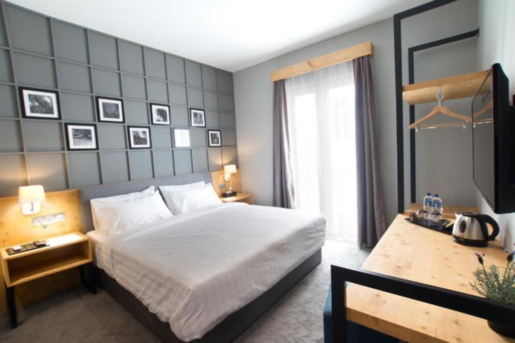 Postel nebo postele na pokoji v ubytování Redpine Boutique Hotel