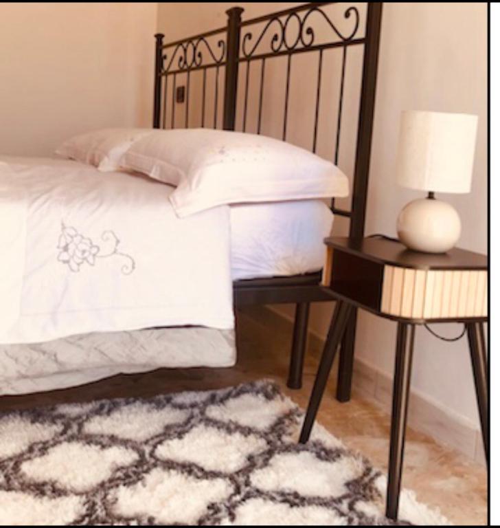 a bedroom with a bed and a table with a lamp at Casale Kintsugi in Cepagatti