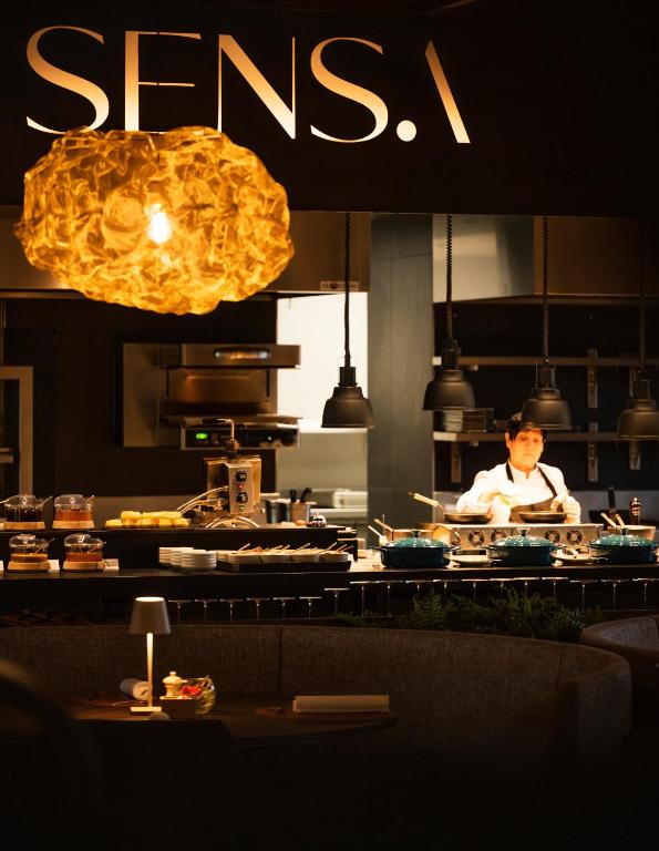 a chef in a kitchen preparing food in a restaurant at Anatura Luxembourg in Weiswampach
