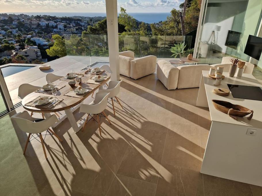 una mesa de comedor y sillas en la sala de estar con vistas en Noahs Paradise, en Benissa