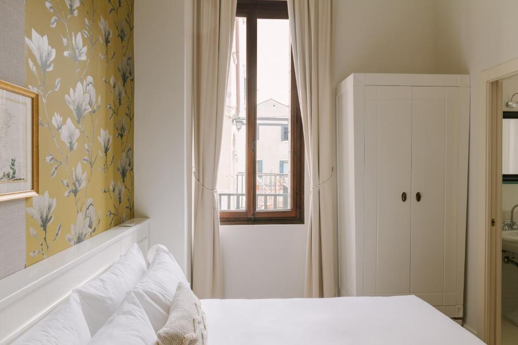 Postel nebo postele na pokoji v ubytování iH Hotels Venezia Salute Palace