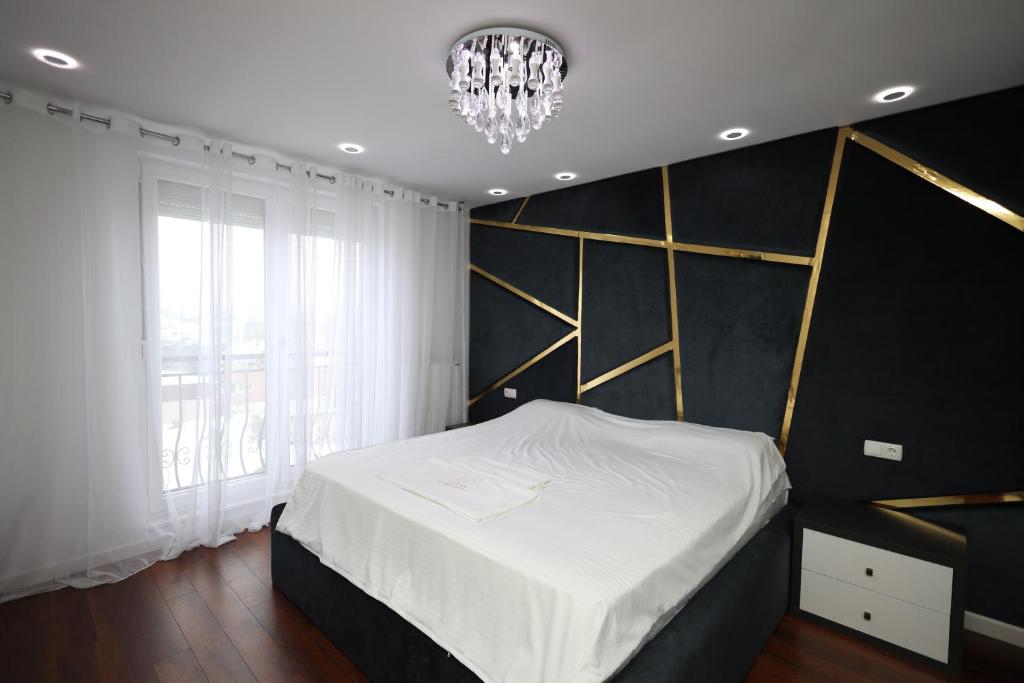 Postel nebo postele na pokoji v ubytování Dodona ApartHotel in Prishtina