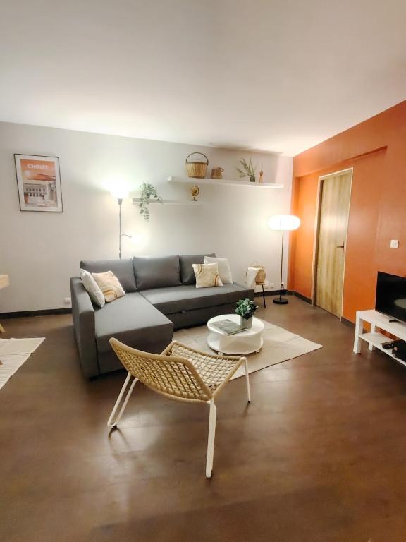 un salon avec un canapé et une table dans l'établissement Appartement plein centre ville, chaleureux et spacieux, à Cholet