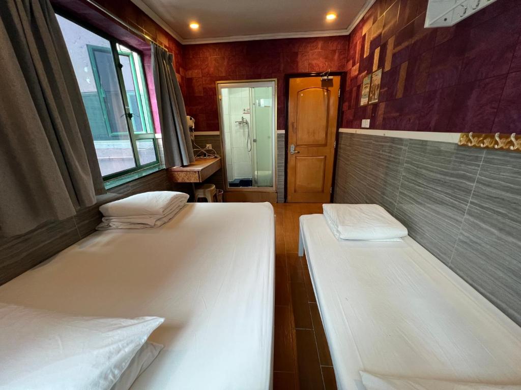 A bed or beds in a room at USA Hostel HONG KONG