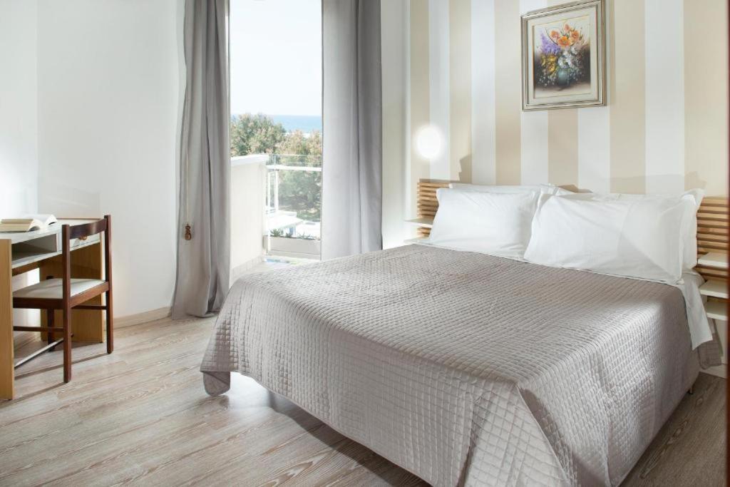 Postel nebo postele na pokoji v ubytování SoleMare Hotel e Residence