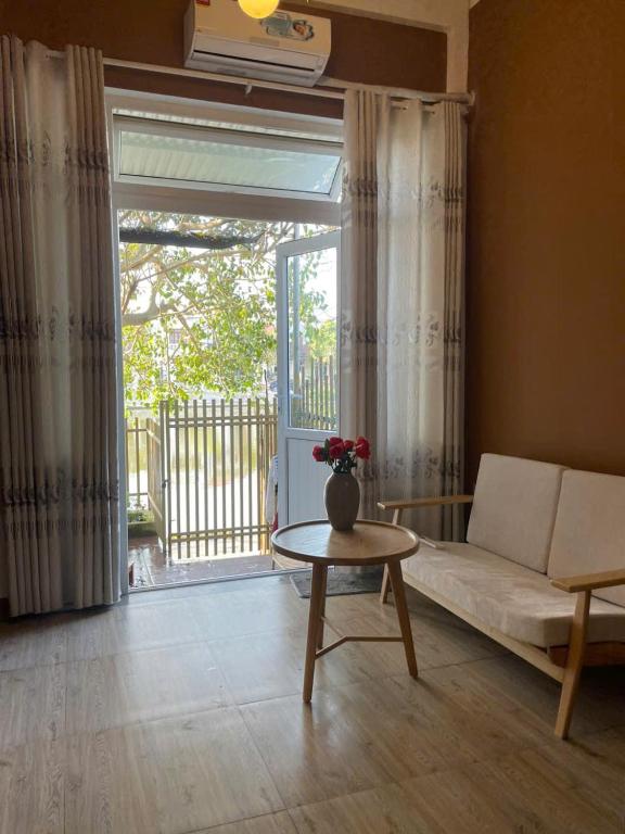 a living room with a couch and a table at Pamela Homestay in Thôn An Hòa