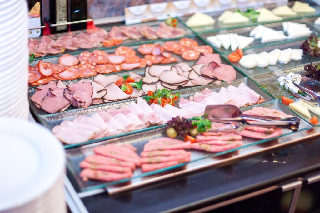 a buffet of meats and cheese and other foods at Continental Forum Sibiu in Sibiu
