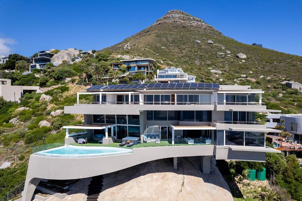 a house on a hill with a swimming pool at The Marvel Beach House in Llandudno