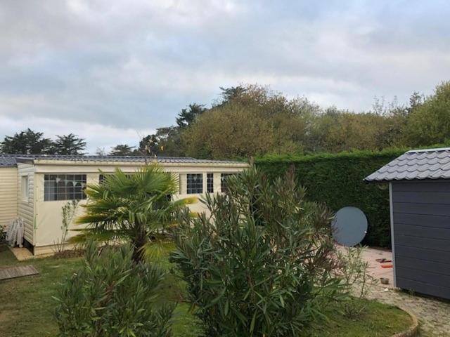 une maison avec un palmier dans une cour dans l'établissement Résidence cote de lumière, à Les Sables-dʼOlonne