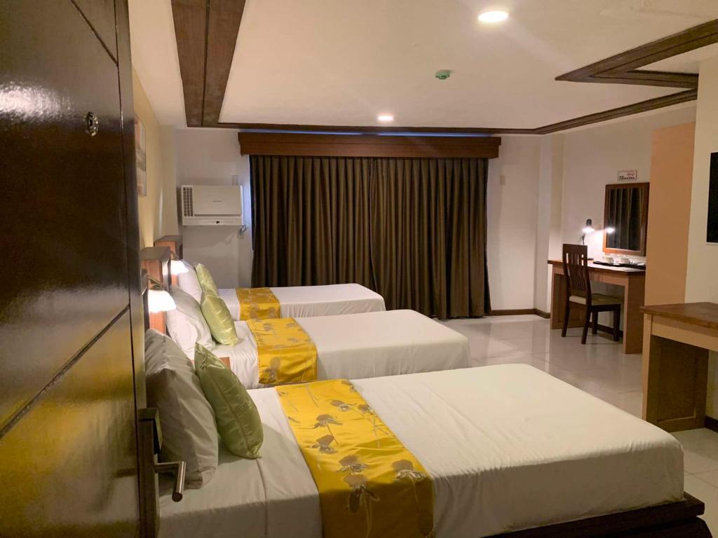 Postel nebo postele na pokoji v ubytování Surigao Royal Regency Suites